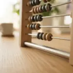 A meticulously designed modern abacus made from polished metal and minimalist wood